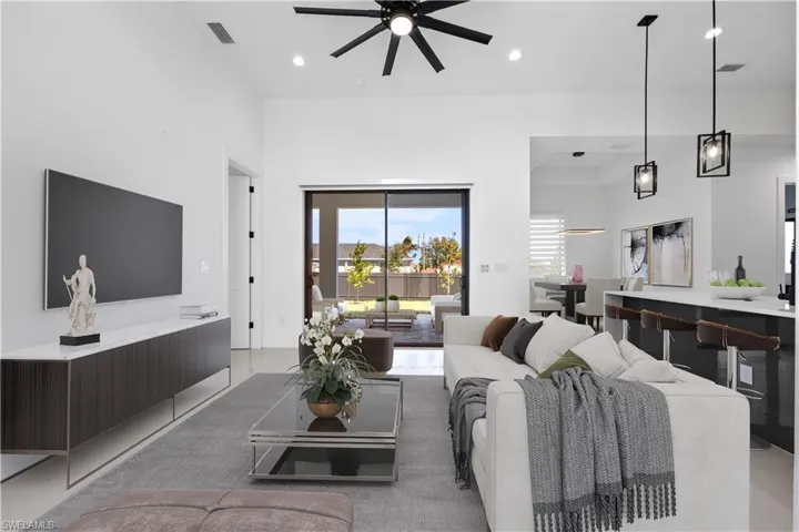 Virtually Staged-Living room with visible vents, recessed lighting, a high ceiling, and ceiling fan