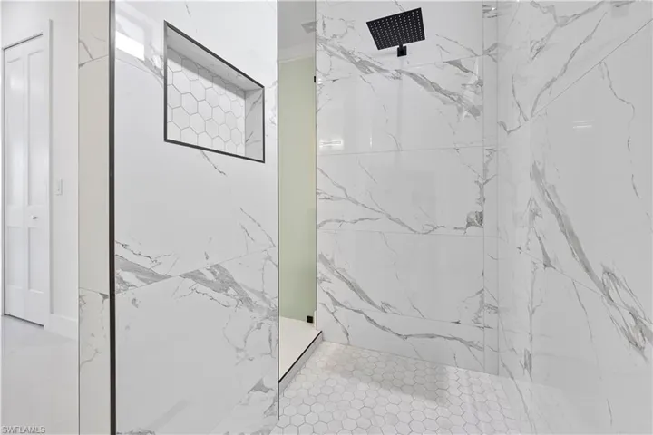 Bathroom featuring a marble finish shower