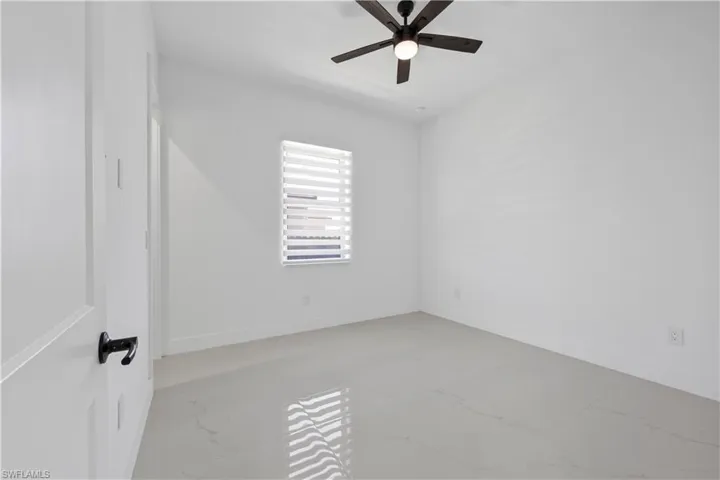 Spare room with baseboards and ceiling fan