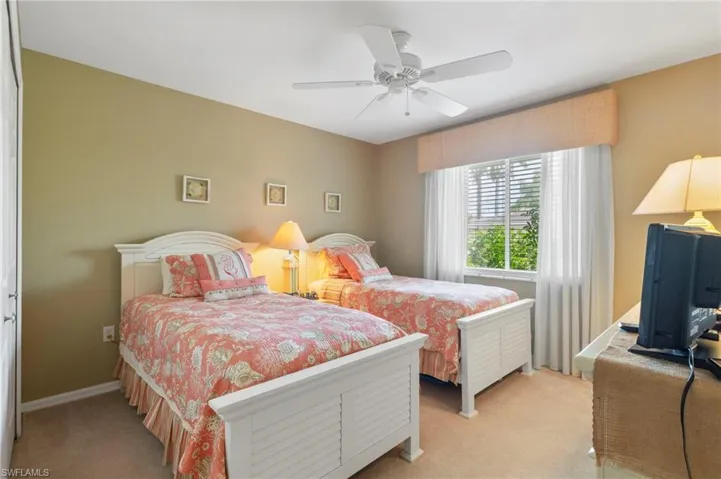 Bedroom with light carpet and ceiling fan