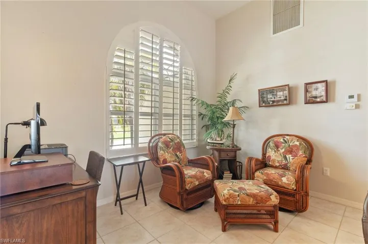 Living area with light tile patterned floors and baseboards