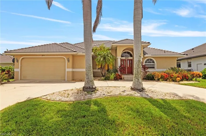 Mediterranean / spanish home featuring concrete driveway, stucco siding, a tile roof, and a garage