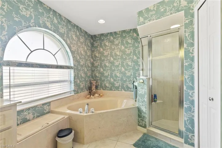 Full bath featuring wallpapered walls, a garden tub, tile patterned flooring, a shower stall, and recessed lighting