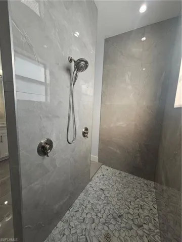 Bathroom with a tile shower and recessed lighting