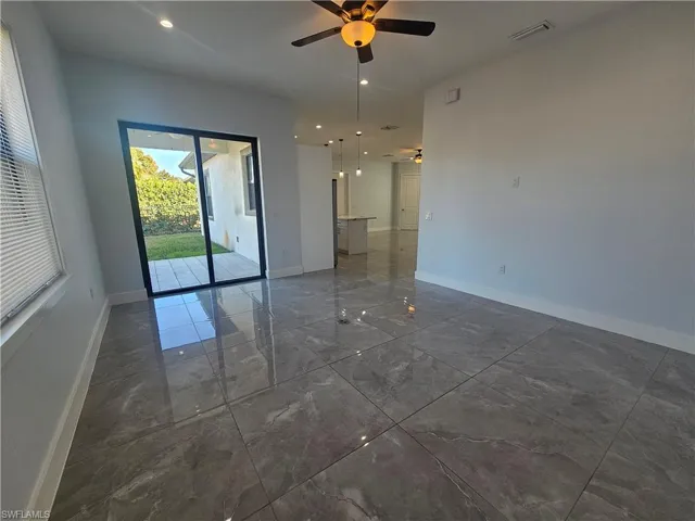 Unfurnished room with ceiling fan, dark marble finish floors, and recessed lighting