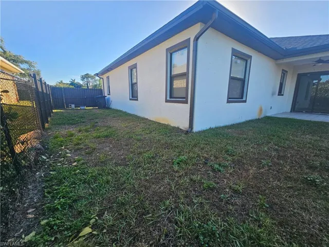 View of home's exterior with a patio, stucco siding, a ceiling fan, and a fenced backyard