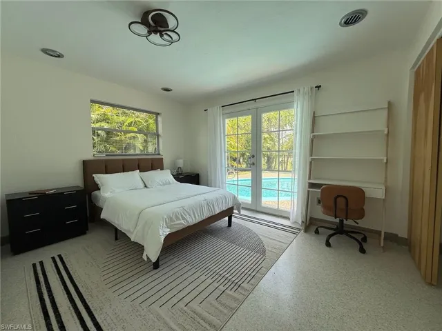 2nd Bedroom featuring access to outside, french doors, and a small desk