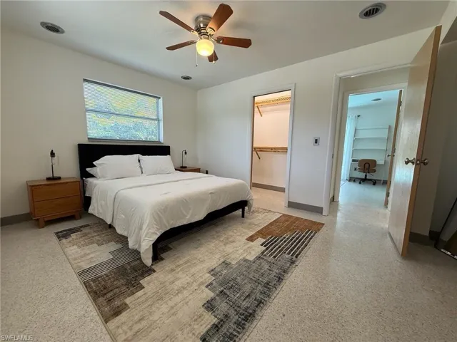 Primary Bedroom featuring a ceiling fan and a spacious closet