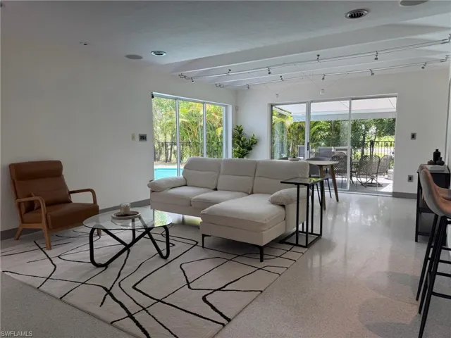 Living room featuring plenty of natural light and different entertainment and seating areas