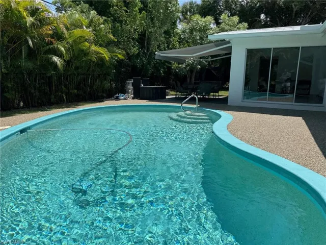 View of swimming pool and covered back patio