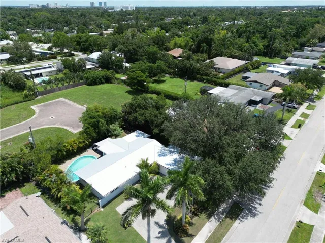 Aerial view of the house with the private and fenced backyard with pool