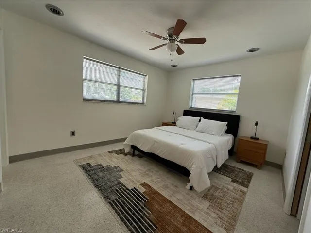 Primary bedroom with a ceiling fan