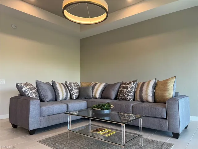 Living room featuring baseboards and light tile patterned floors