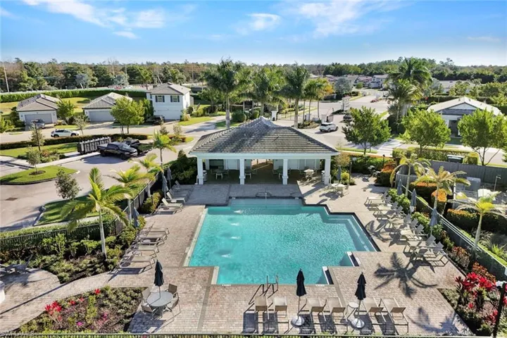 Aerial view of swimming pool with a patio and cabana
