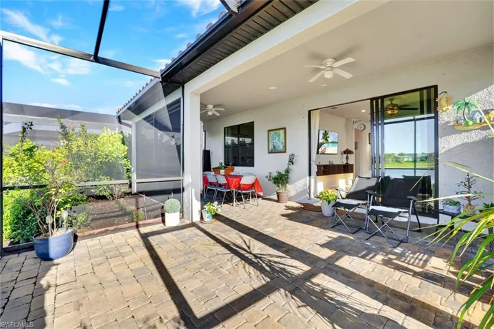 Sunroom / solarium with ceiling fan and a patio