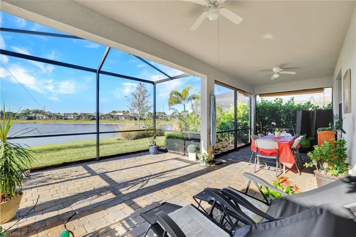 Sunroom / solarium with a residential view and a water view