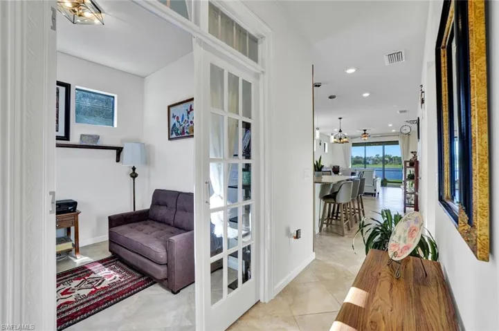 Hallway with french doors and light tile floors