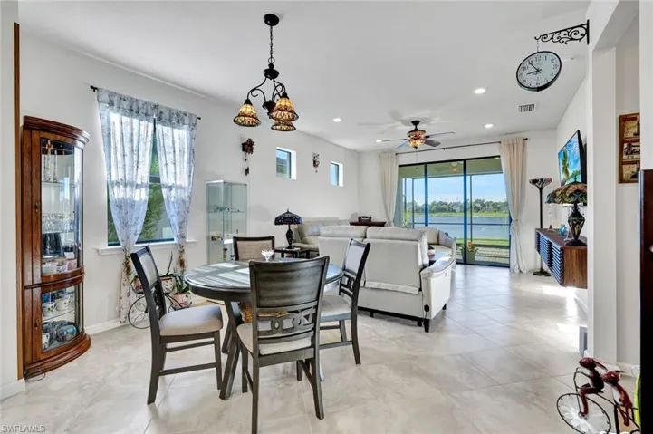 Dining area with healthy amount of natural light, ceiling fan, recessed lighting, and light tile patterned floors