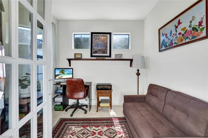 Office area featuring light tile patterned floors and french doors