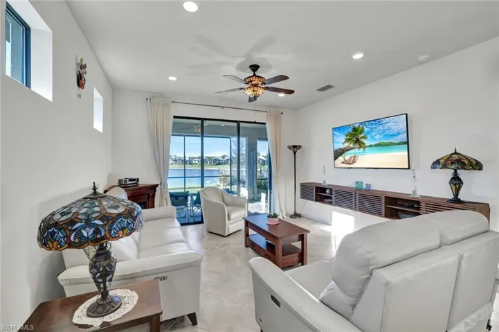 Living area featuring ceiling fan and recessed lighting