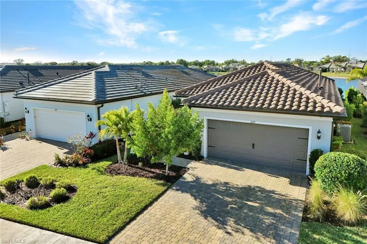 View of front of home featuring a tile roof and driveway