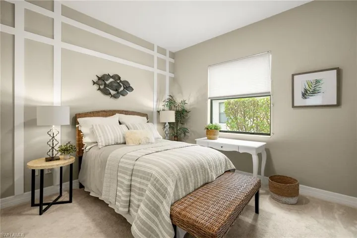 View of carpeted guest bedroom #1 with decorator wall upgrade.