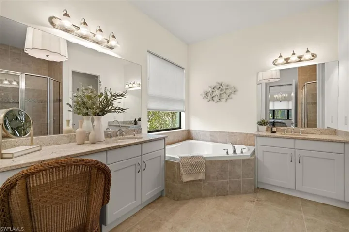 Bathroom featuring tile patterned flooring, vanity, and independent shower and bath, upgraded lighting