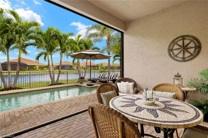 View of custom salt water, solar heated swimming pool with a panoramic screen for sunset water view