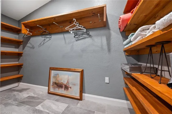 Walk in closet featuring vaulted ceiling