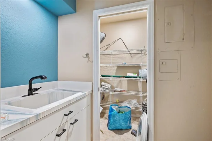 Bathroom featuring vanity and a textured wall