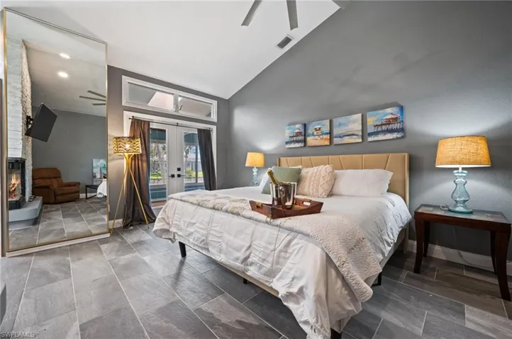 Bedroom with access to outside, french doors, high vaulted ceiling, and a ceiling fan