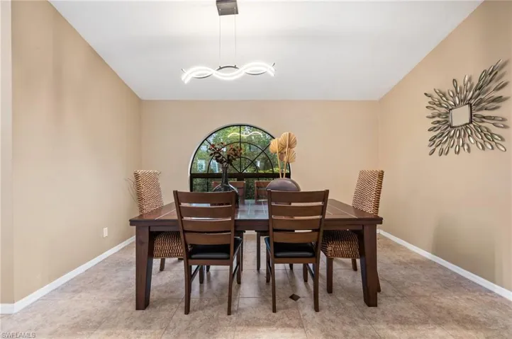 Dining area with a chandelier and baseboards
