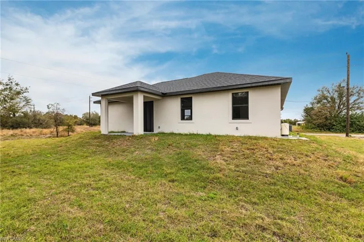 Back of property with a yard