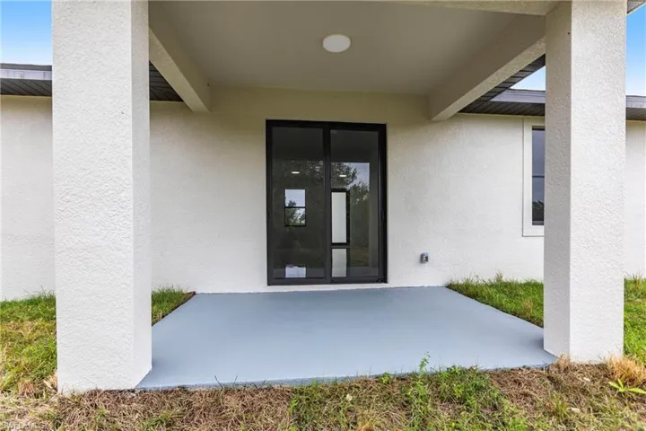 Entrance to property with a patio