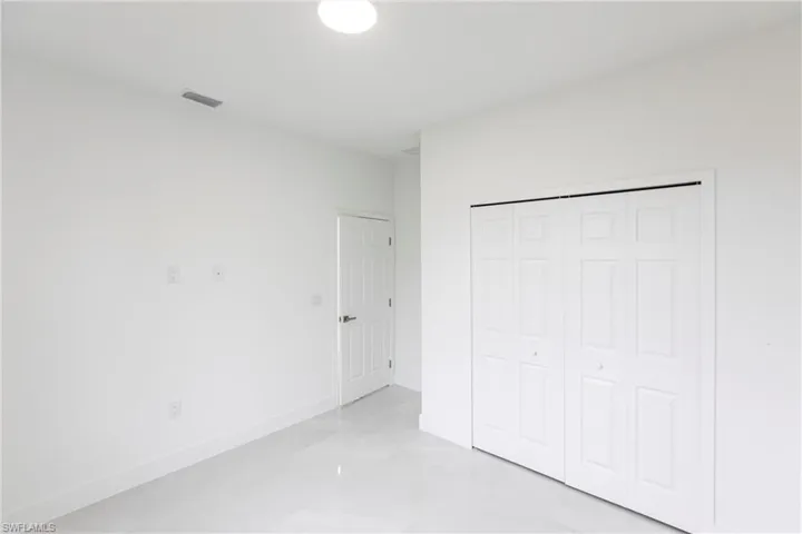 Unfurnished bedroom featuring a closet and light tile patterned flooring