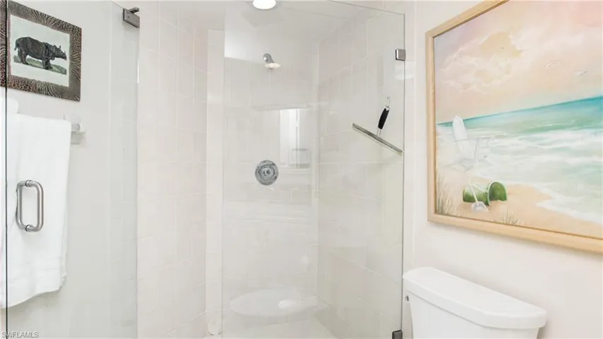 Bathroom featuring walk in shower and toilet