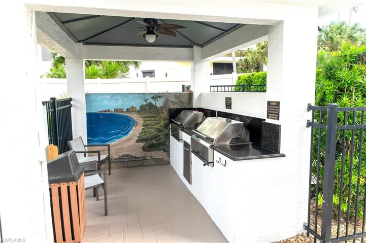 View of patio featuring a grill, a gazebo, ceiling fan, and an outdoor kitchen
