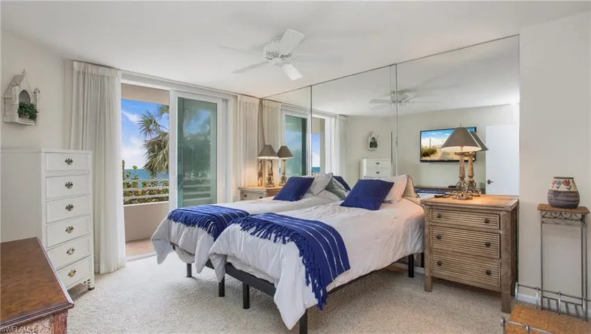 Carpeted bedroom with ceiling fan