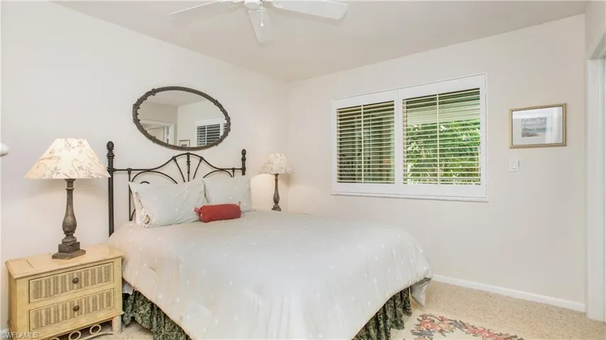 Bedroom featuring ceiling fan and carpet floors