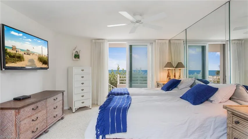 Carpeted bedroom with access to outside and ceiling fan