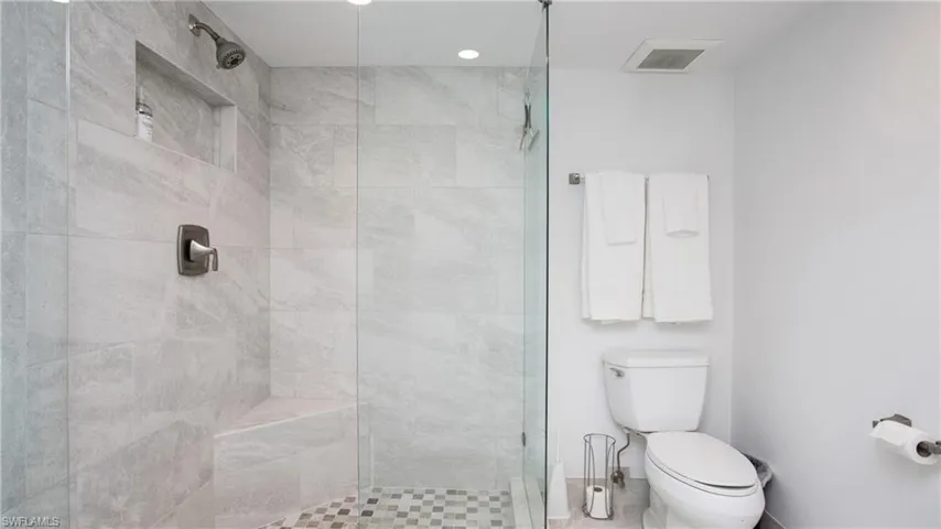 Bathroom featuring toilet and tiled shower
