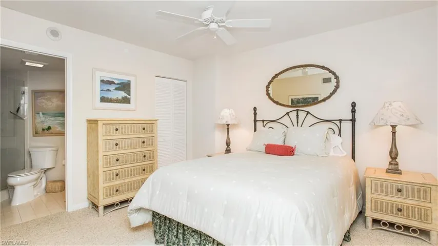 Bedroom featuring carpet, connected bathroom, ceiling fan, and a closet