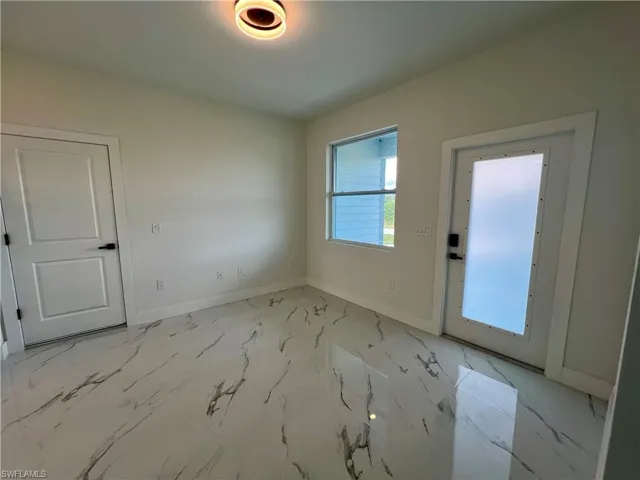 Living room with 32 X 32 polished porcelain floors and LED lighting.