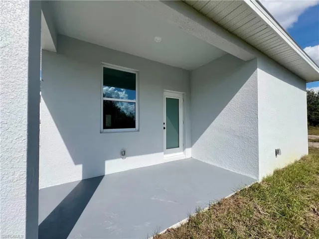 Covered rear porch overlooking the backyard