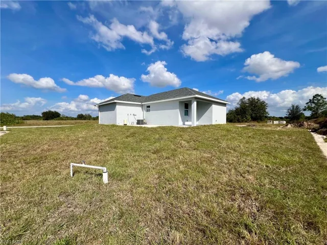 View of side of property featuring a lawn