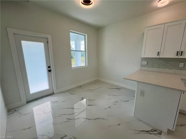 View of dining area off kitchen with breakfast bar.