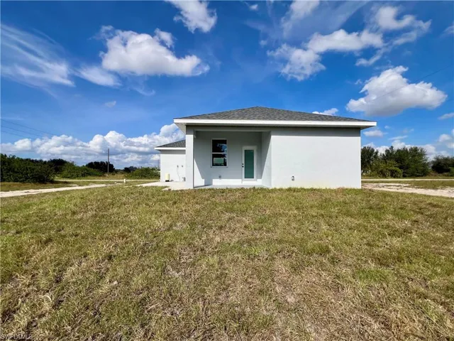 Rear view of house with a yard