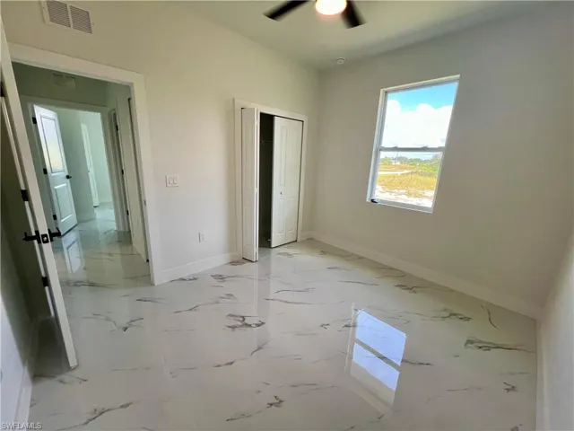 Guest bedroom featuring ceiling fan and a closet
