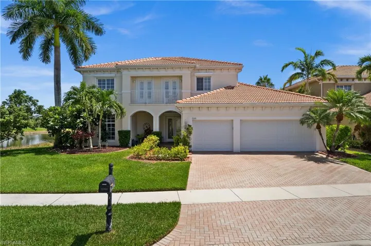What a beautiful style house with a balcony, a garage, and a front yard.
