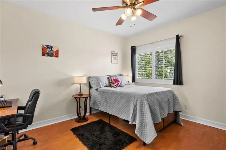 Bedroom with hardwood / wood-style flooring and ceiling fan